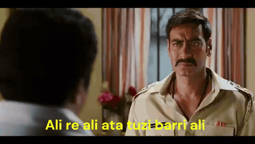 A Man With A Mustache Is Talking To Another Man And The Words Ali Re Ali Ata Tuzt Barri Ali Are On The Screen GIF