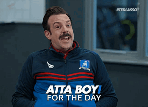 A Man With A Mustache Is Wearing A Blue Jacket That Says Atta Boy For The Day GIF