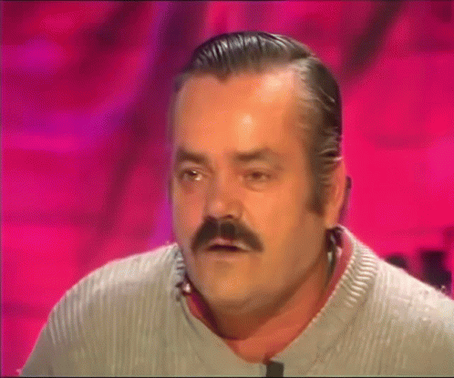A Man With A Mustache Is Wearing A Grey Sweater And Making A Funny Face GIF