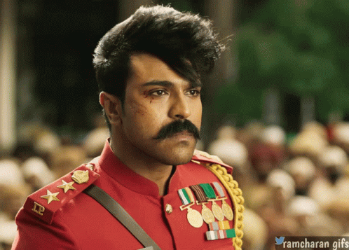 A Man With A Mustache Is Wearing A Red Uniform With Medals On The Sleeves GIF