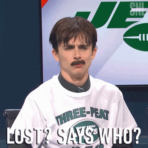 A Man With A Mustache Is Wearing A Shirt That Says Three-Peat On It GIF