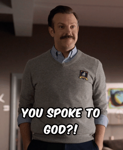 A Man With A Mustache Is Wearing A Sweater That Says You Spoke To God On It GIF