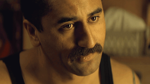 A Man With A Mustache Is Wearing A Tank Top GIF