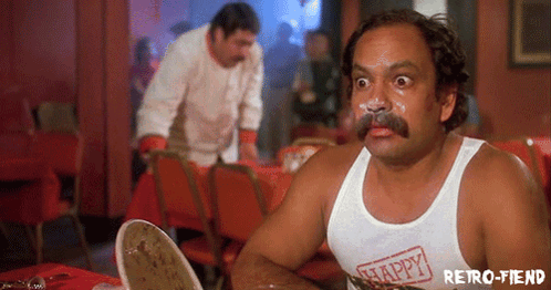 A Man With A Mustache Is Wearing A White Tank Top That Says Happy On It GIF