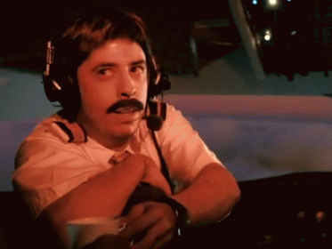 A Man With A Mustache Is Wearing Headphones And A Headset GIF