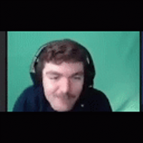 A Man With A Mustache Is Wearing Headphones And Making A Funny Face . GIF