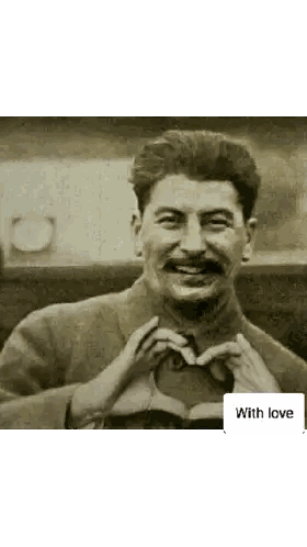 a man with a mustache making a heart with his hands