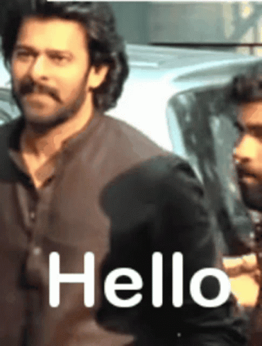 A Man With A Mustache Says Hello To Another Man GIF