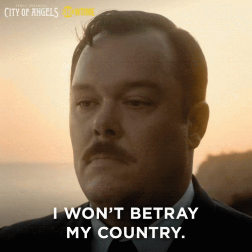 A Man With A Mustache Says " I Won 'T Betray My Country " In Front Of A Sunset GIF