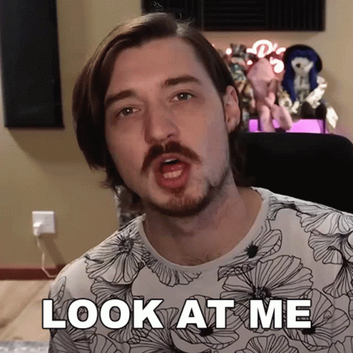 a man with a mustache says " look at me "