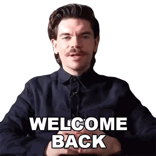 a man with a mustache wearing a black shirt says welcome back