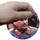 a man with a mustache wearing a hat and a military uniform .