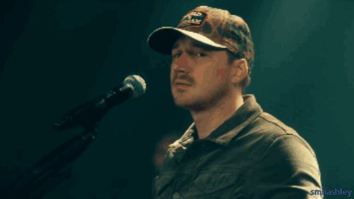 A Man With A Mustache Wearing A Hat That Says Old Dominion GIF