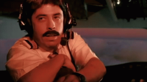 A Man With A Mustache Wearing Headphones And A Microphone GIF