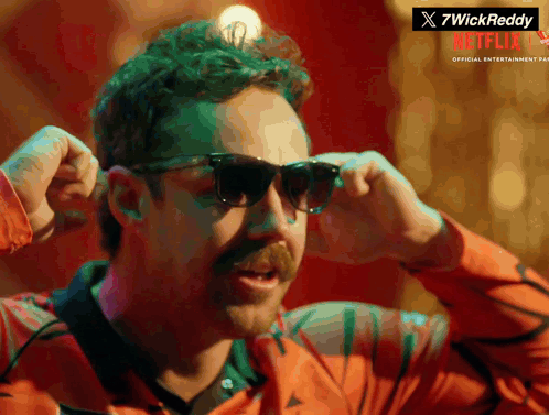 A Man With A Mustache Wearing Sunglasses With A Netflix Logo In The Corner GIF