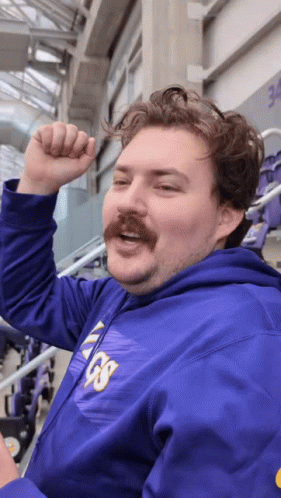 A Man With A Mustache Wears A Purple Vikings Hoodie GIF