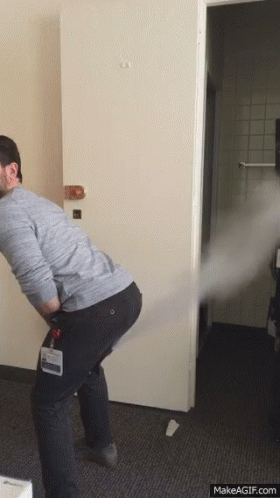 A Man With A Name Tag That Says ' Chris ' On It Is Standing In Front Of A Door GIF