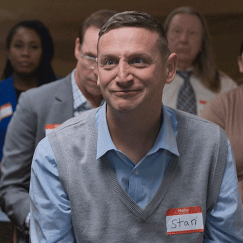 A Man With A Name Tag That Says Hello Stan GIF