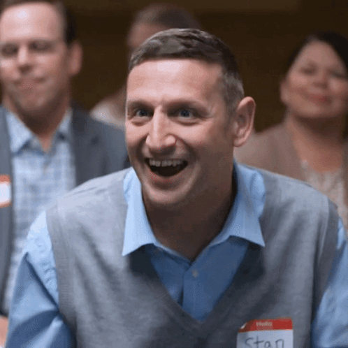 A Man With A Name Tag That Says Stan GIF