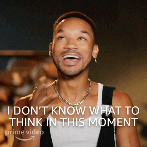 A Man With A Necklace Is Laughing With The Words " I Don 'T Know What To Think In This Moment " Above Him GIF
