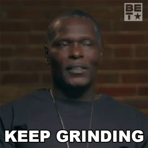 A Man With A Necklace Is Making A Funny Face And Saying `` Keep Grinding '' . GIF