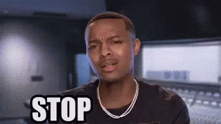 A Man With A Necklace Is Making A Stop Sign . GIF