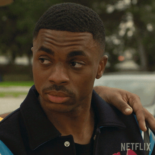 A Man With A Netflix Logo On His Shirt GIF