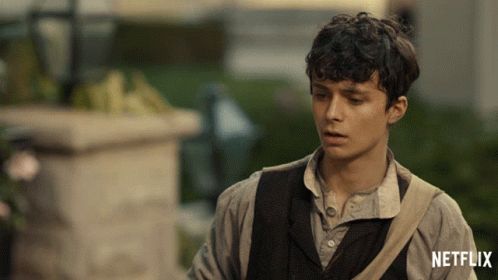 A Man With A Netflix Logo On The Bottom Of His Shirt GIF