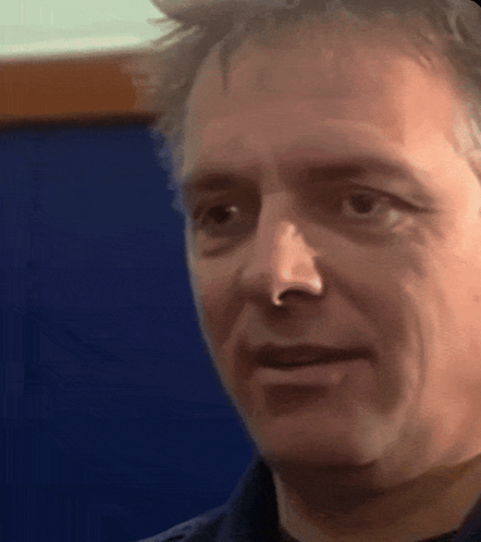 A Man With A Nose Ring Looks At The Camera GIF