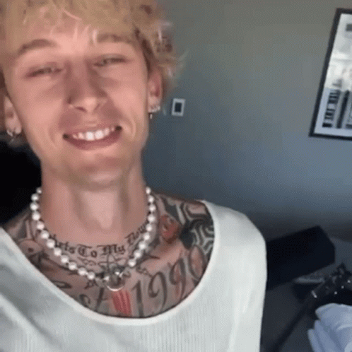 A Man With A Pearl Necklace Around His Neck Has A Tattoo On His Chest That Says " 1995 " GIF