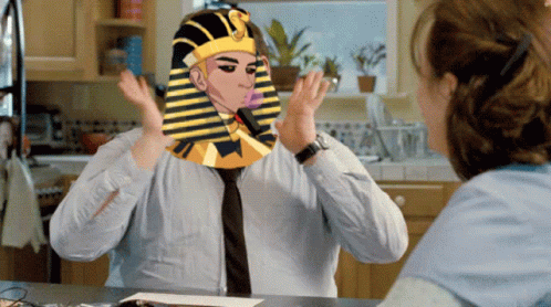 A Man With A Pharaoh 'S Hat On His Head Talks To A Woman GIF