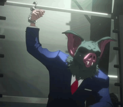A Man With A Pig Mask On His Head Is Handcuffed To A Railing GIF