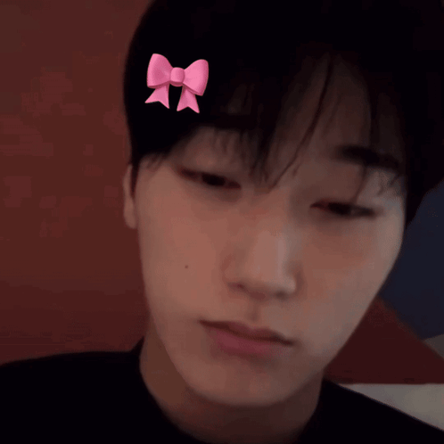 A Man With A Pink Bow On His Head GIF
