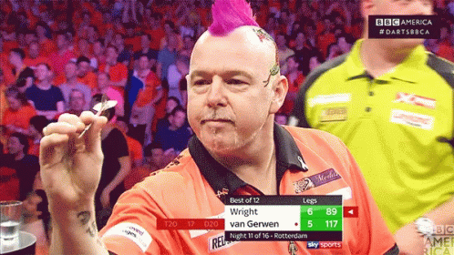 A Man With A Pink Mohawk Is Holding A Dart GIF