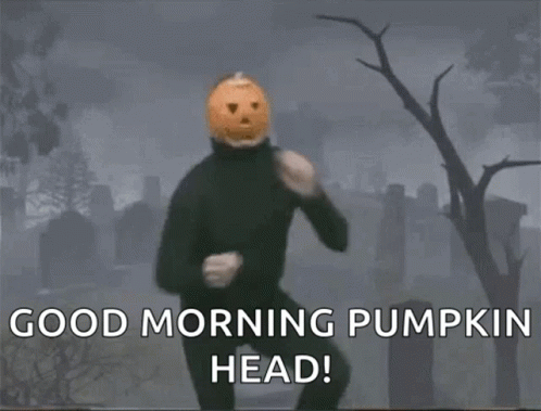 A Man With A Pumpkin Head Is Dancing In A Cemetery GIF