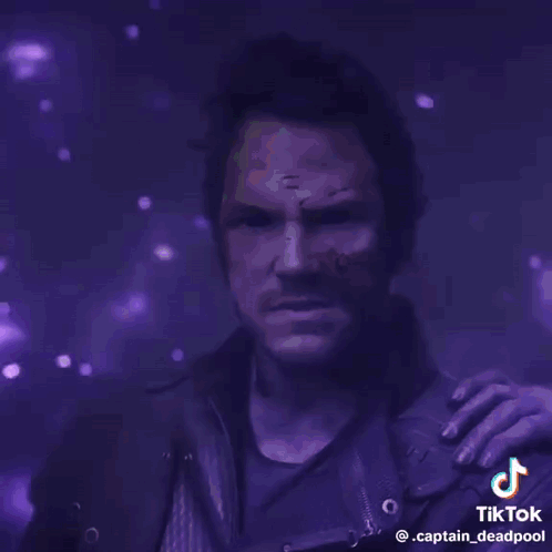 A Man With A Purple Background And The Words Guns Of The Galaxy On It GIF