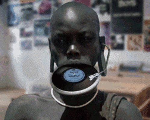 a man with a record in his mouth and headphones