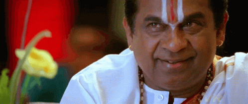 A Man With A Red And White Stripe On His Forehead Smiles For The Camera GIF