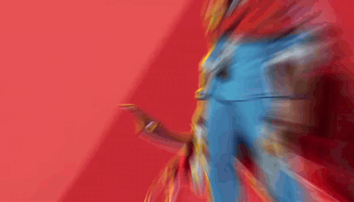 A Man With A Red Cape Is Holding A Gun In Front Of A Red Background GIF