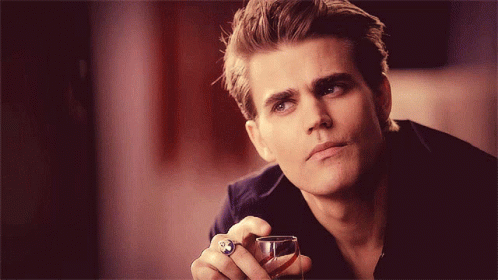 A Man With A Ring On His Finger Holds A Glass GIF