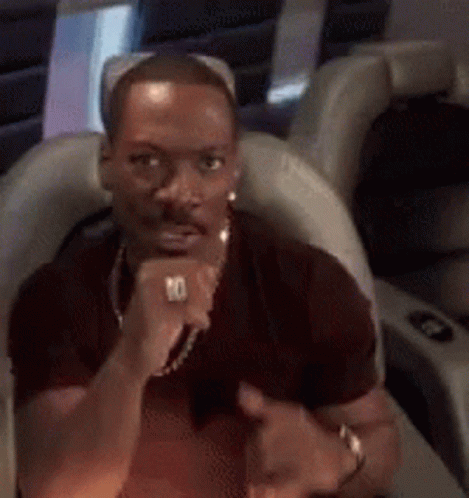 A Man With A Ring On His Finger Is Giving A Thumbs Up . GIF