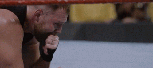 A Man With A Ring On His Finger Is Kneeling In A Boxing Ring GIF