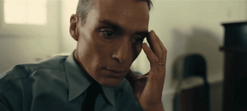 A Man With A Ring On His Finger Looks At Something GIF