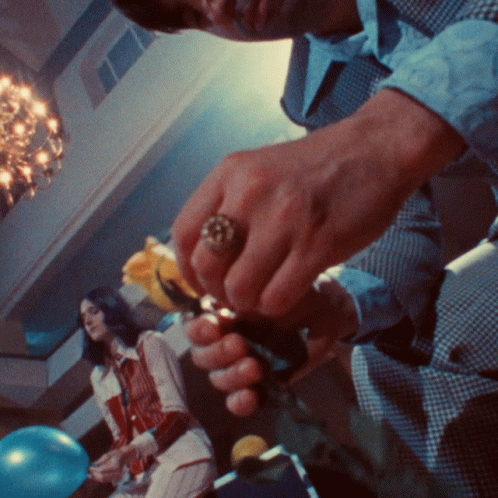 A Man With A Ring On His Finger Opens A Bottle Of Wine GIF