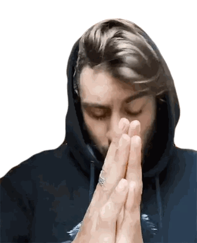 a man with a ring on his finger prays with his hands folded