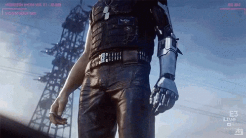 a man with a robot arm is standing in front of a tower