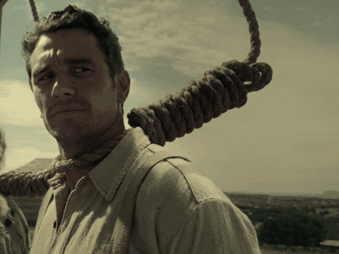 A Man With A Rope Around His Neck Is Looking At The Camera GIF