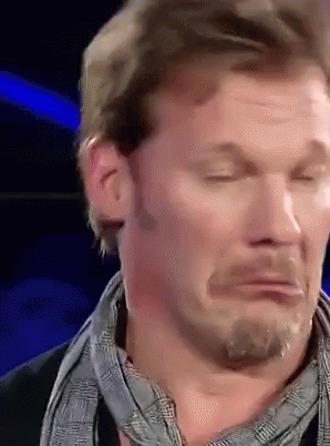 A Man With A Scarf Around His Neck Is Making A Funny Face With His Eyes Closed GIF