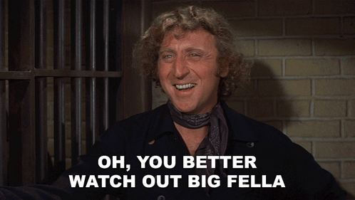 A Man With A Scarf Around His Neck Is Smiling And Says Oh You Better Watch Out Big Fella GIF