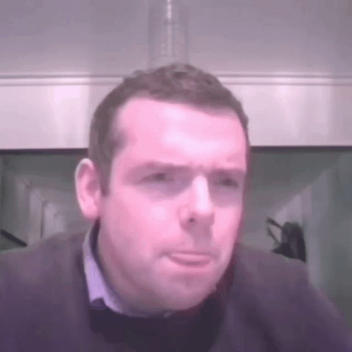 A Man With A Serious Look On His Face Is Wearing A Sweater GIF